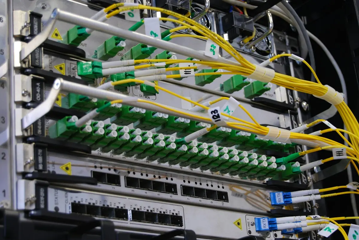 Fiber links patched into one provider's rack, where a zone with every nameserver on one network fails in a single outage