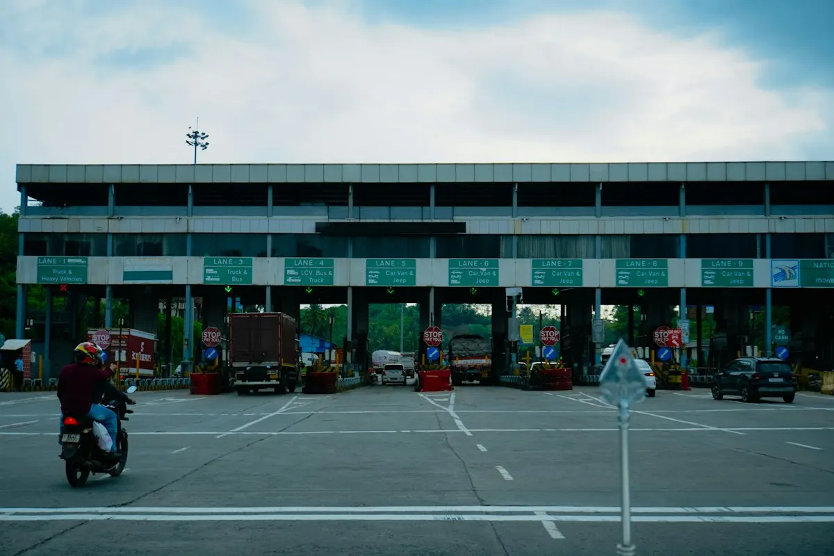 A toll plaza with separate lanes for trucks, buses and cars, the sorting an ingress controller does for every hostname and path