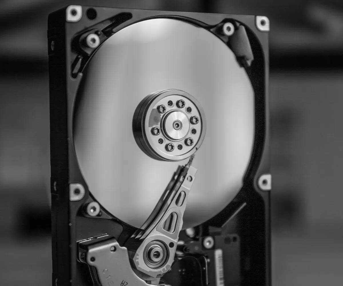 An opened hard disk drive in black and white, platter and read arm visible: where a self-managed WAL archive ends up