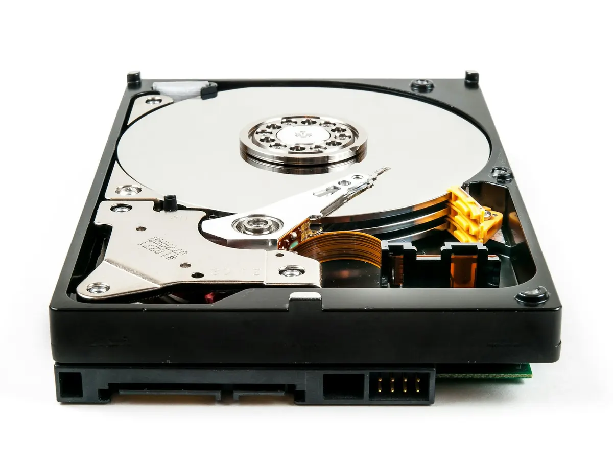 Opened hard disk drive with its SATA data and power connectors visible at the back