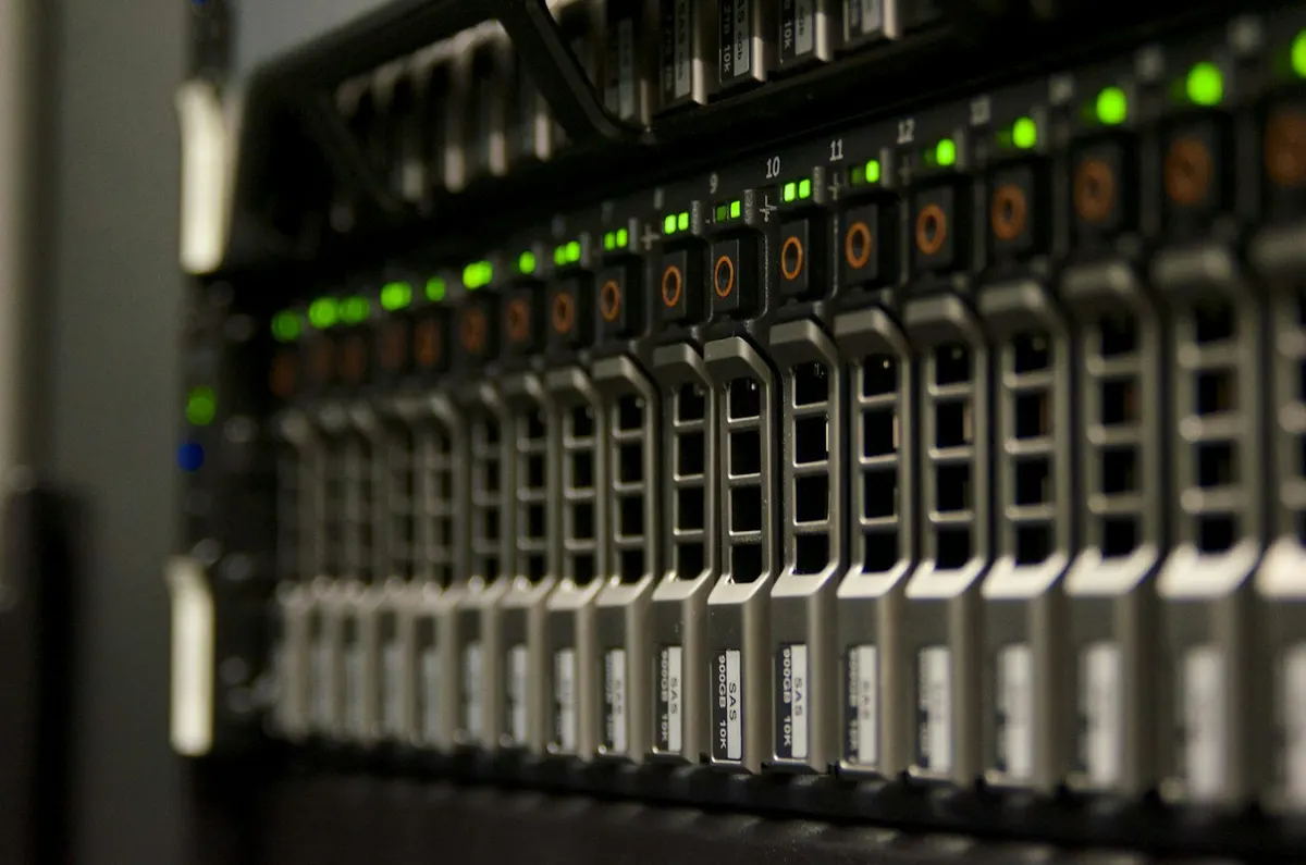 Front of a rack server with rows of hot-swap SAS drive bays and green activity lights