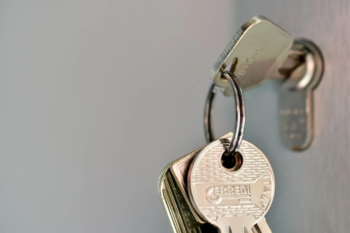 A key ring hanging from a key left in a door lock, the credential to replace before touching git history